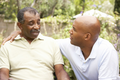 senior man and caregiver looking at each other