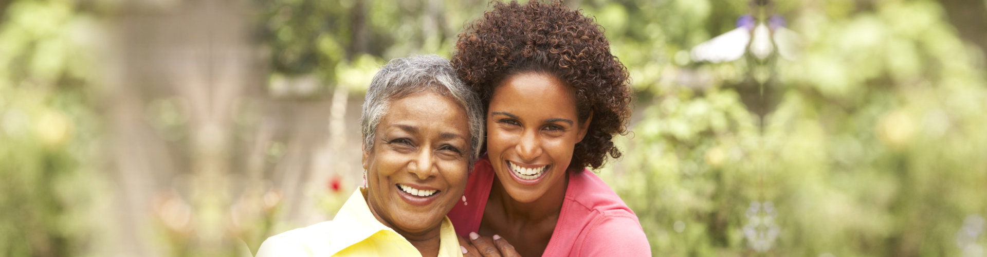 caregiver and senior on outdoor smiling