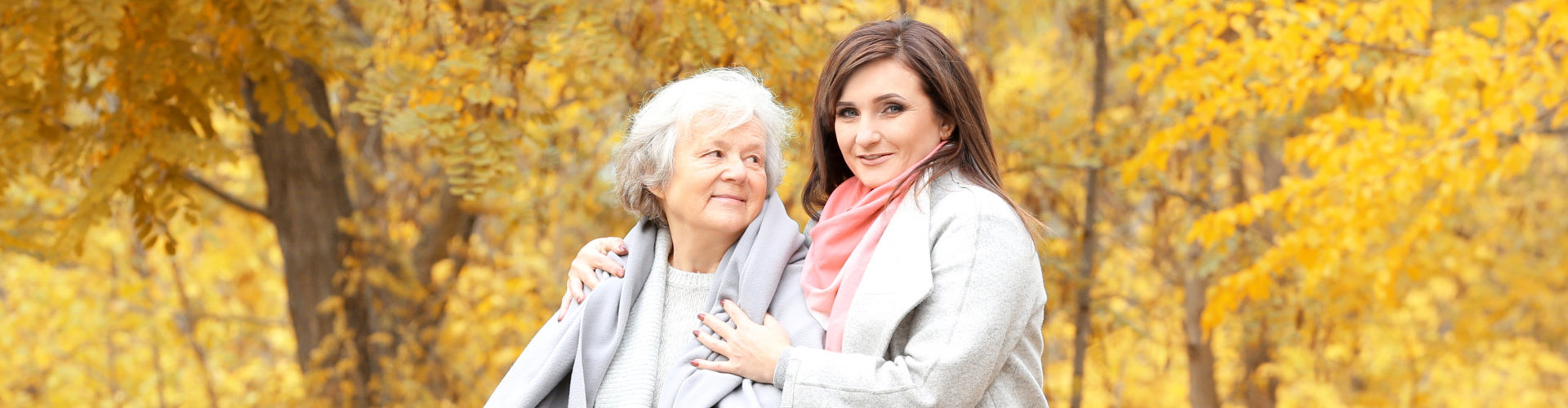 caregiver with her senior patient smiling